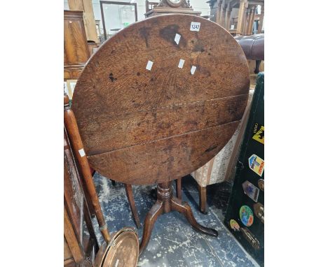 An 18th century oak tilt top tripod table.