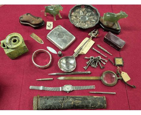 A  hallmarked silver cigarette case, A silver hinged bangle, a pierced silver dish, a pair of green hardstone Chinese figures