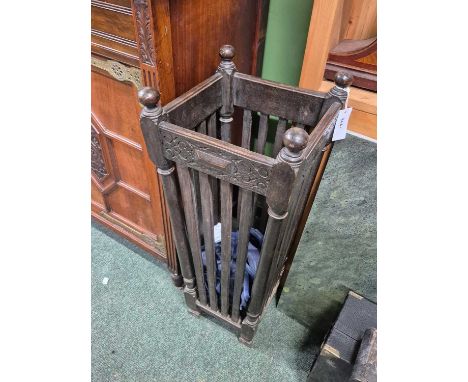 An oak strap sided stick stand, the square sectioned sides tapering to block feet