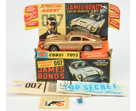 Corgi Toys 261 "James Bond" Aston Martin DB5 "Goldfinger" - Gold body, red interior with "James Bond &amp; Bandit" figures, s