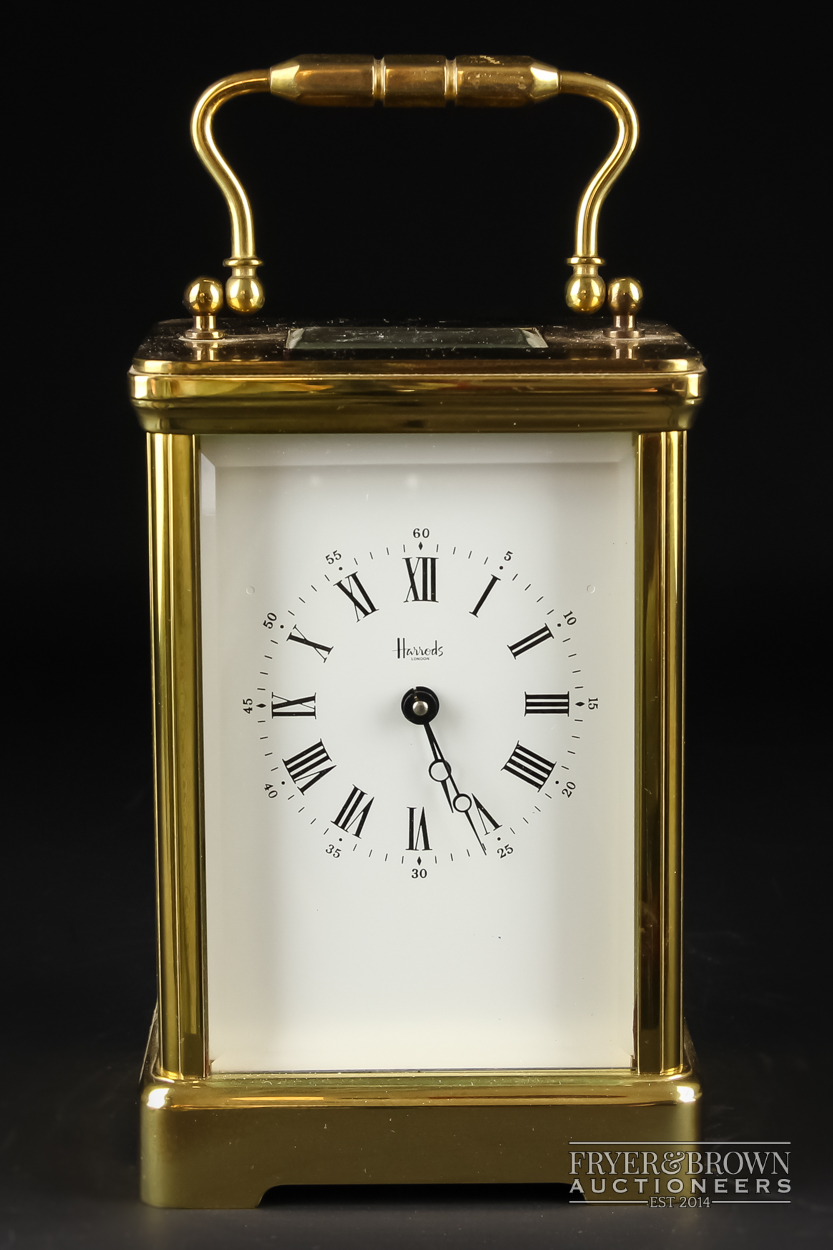 A Harrods brass cased carriage clock, the movement stamped Angelus