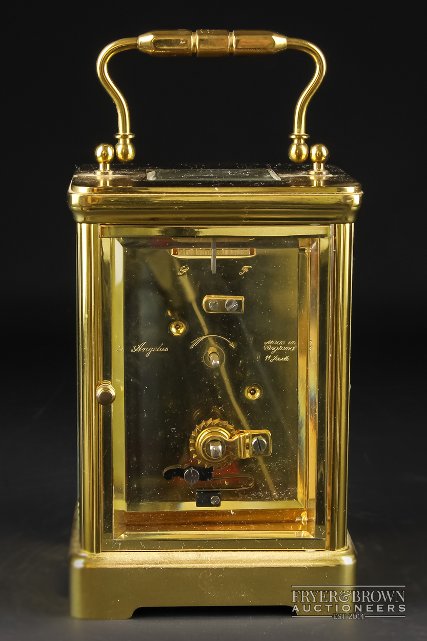 A Harrods brass cased carriage clock, the movement stamped Angelus