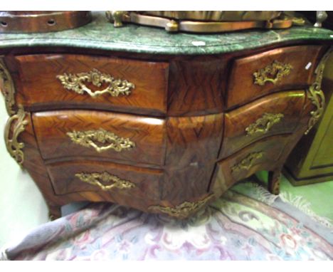 A mid 20th century French serpentine commode in the 18th century style, fitted with six short drawers with geometric parquetr