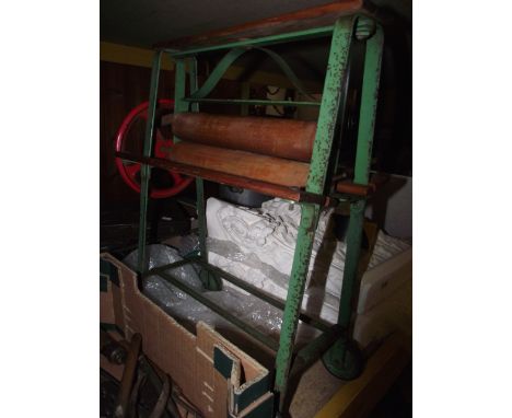 A vintage Tri-ang child's working toy mangle with original painted steel frame and moveable wheels