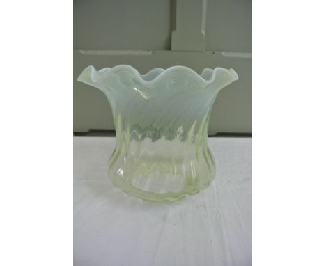 A reproduction Vaseline glass oil lamp, wrythen moulded shade with crimped edge.