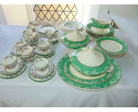 A collection of Royal Cauldon Art Deco dinner wares with stylised leaf border decoration on a green and gilt ground comprisin