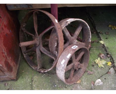 Three small vintage cast iron spoke wheels of varying size