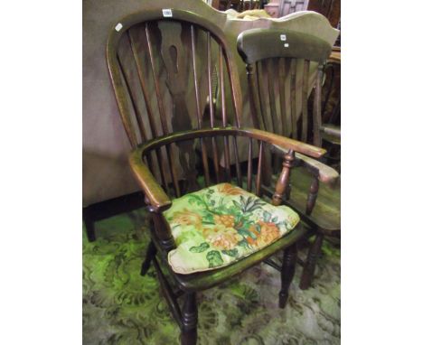 An early 19th century Windsor comb back elbow chair principally in ash and elm wood