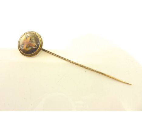 A Victorian stick pin, terminating with a ceramic plaque painted with a fox head, signed W. Essex 1863?