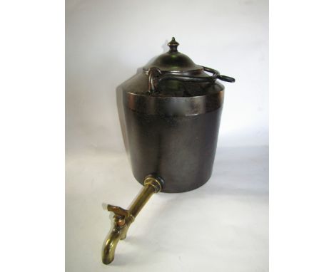 A substantial good quality cast iron hopper/kettle with an elongated applied brass tap and looping handle