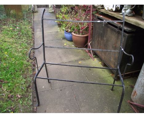 An ironwork two seat garden bench frame with shaped outline