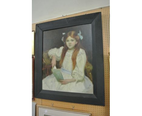 An early 20th century oil painting on canvas half length portrait of a young girl seated and reading in a white dress with bl