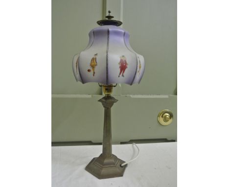 An Edwardian cast brass electric table lamp with tapered hexagonal column and stepped base beneath a moulded coloured glass s