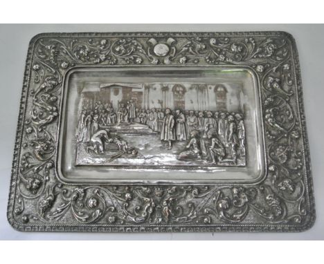 A 19th century Spanish silver plated panel of rounded rectangular form, the central scene detailing a royal court, portraying