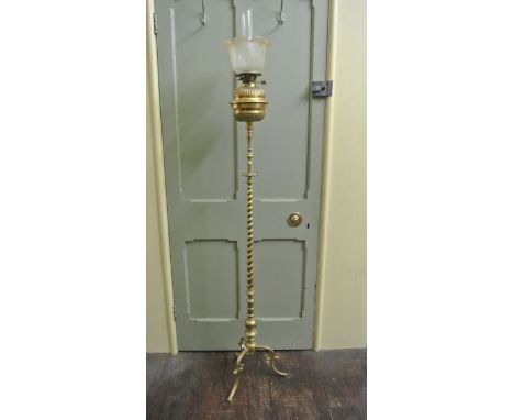A polished brass oil lamp standard with partial rope twist column and knopped stem, scroll tripod, fluted brass font with ass