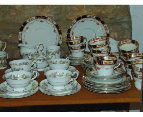 A collection of Paragon Highland Queen pattern tea wares with thistle detail comprising four cups, four saucers, four tea pla