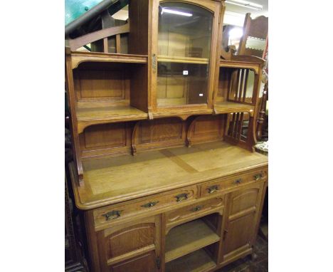 A late 19th century continental oak buffet, the geometric base enclosed by two cupboards and three drawers with open centre, 