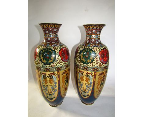 A pair of baluster shaped Chinese cloisonné enamel vases with multi-medallion decoration detailing dragons, birds and beasts 