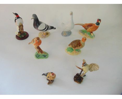 A collection of ceramic models of birds including John Beswick examples comprising a grey pigeon, a pheasant and a partridge,