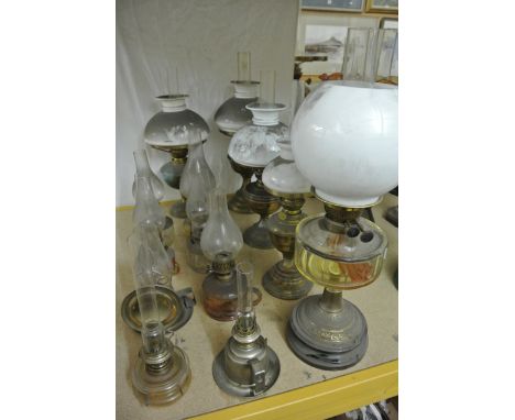 A Victorian oil lamp with globular milk glass shade, brass British made Duplex burner, faceted glass reservoir, domed brass s