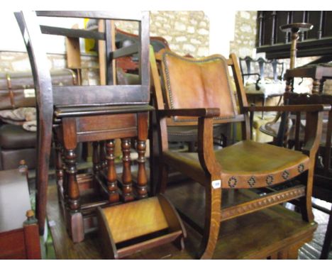 A 1930s oak framed fireside chair with hide upholstered seat and back panel, a nest of three oak graduated occasional tables,