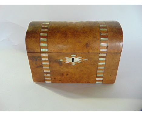 An antique walnut veneered tea caddy of domed form with mother of pearl inlaid detail to exterior, the hinged lid revealing a