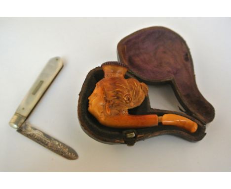 A small cased Meersham pipe, in the form of a female head, together with a silver bladed fruit knife, with mother-of-pearl ha