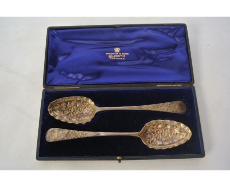 A cased pair of George III silver Old English pattern berry spoons, William Sumner I, London, 1790, each bowl chased with gil