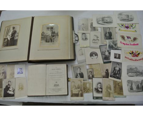 A Victorian embossed leather photographic portrait album together with a number of loose portrait cards