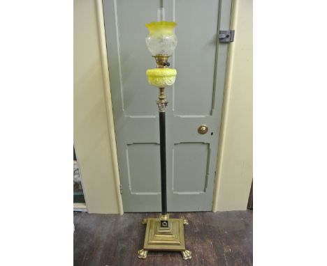 A Victorian brass oil lamp standard in the form of a Corinthian column with ebonisedreeded stem, square stepped base, shaped 