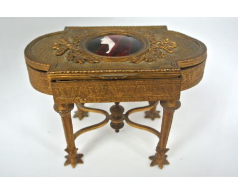 A 19th century gilded brass jewel or trinket box, the lid enclosing an enamelled portrait of St Fabiola -the case work with t