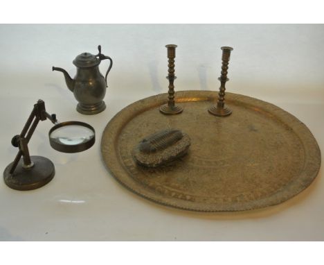 A substantial eastern brass tray of circular form with embossed detail raised on a folding timber frame together with an adju