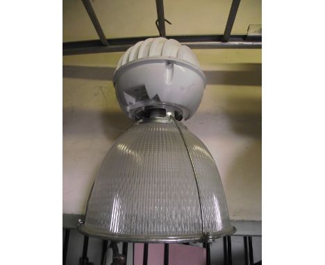 An Industrial hanging ceiling light, with globe-shaped fitting and domed Holophane Prismalume glass shade (converted for ligh