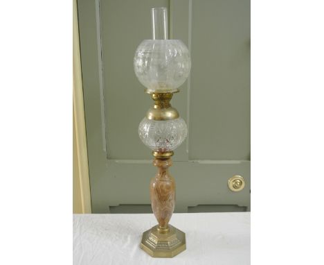 A vintage oil lamp with globular Christopher Wray etched glass shade, moulded glass reservoir, vase shaped marbled stem and s