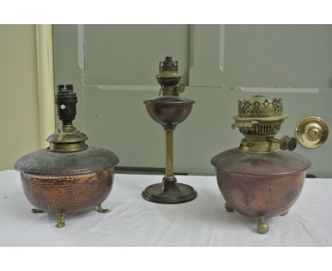 A small Benson style oil lamp principally in copper with dished circular base and reeded brass column, stamped with registrat