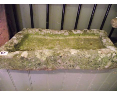 A shallow weathered trough/bird bath of irregular rectangular form, 60 cm x 30 cm approx