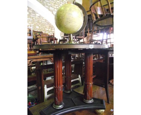 A contemporary globe 16 inches diameter approx, raised on a circular table in turned raised on three turned and fluted mahoga