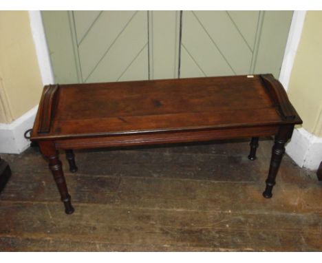 A late 19th century early 20th century oak hall bench or window stool with moulded detail raised on four ring turned and tape
