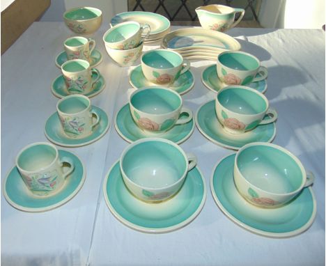 A collection of Susie Cooper wares comprising six tea cups and six saucers, with painted pale pink rose detail, Dresden Spray