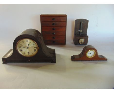 A 1930's oak cased mantel clock, with three train movement, a small metronome with a carved wood case, a small tower of six d
