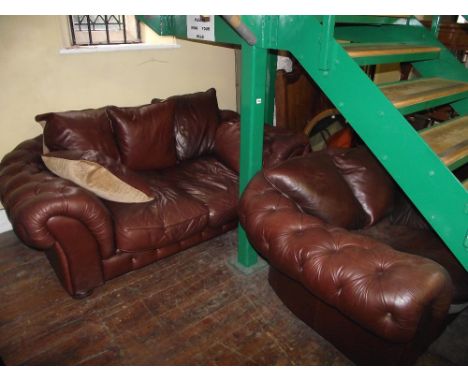 A substantial contemporary mid tan coloured leather two seat sofa and matching chair in the Chesterfield style with deep butt