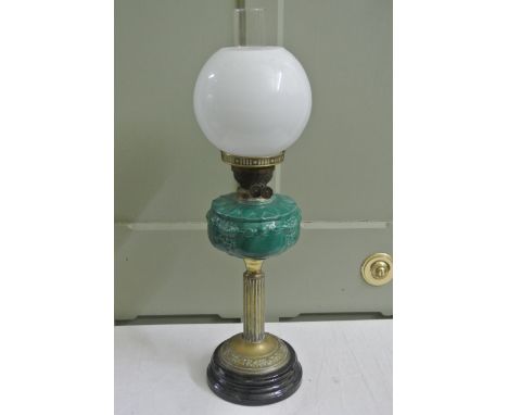 A Victorian oil lamp, the turquoise coloured ceramic reservoir with foliate detail, globular milk glass shade, reeded brass s