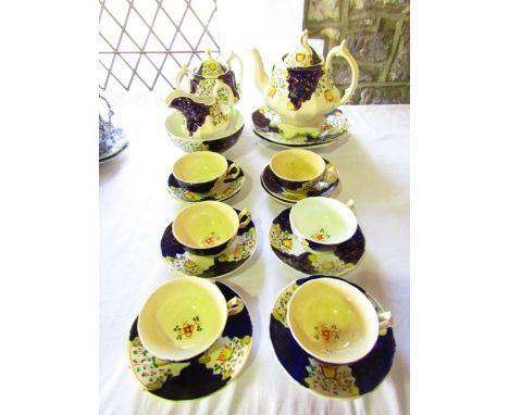 A collection of 19th century Gaudy type tea wares with painted and gilded stylised tulip decoration comprising a teapot, cove