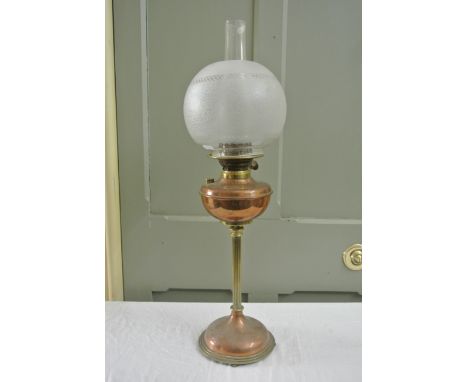 In the manner of W A S Benson a good quality copper and brass oil lamp with domed and stepped circular base with four boned f