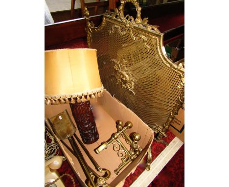 A desk lamp with a carved Chinese bamboo base, good quality brass fire dogs, a fireside trio and further brass fire screen
