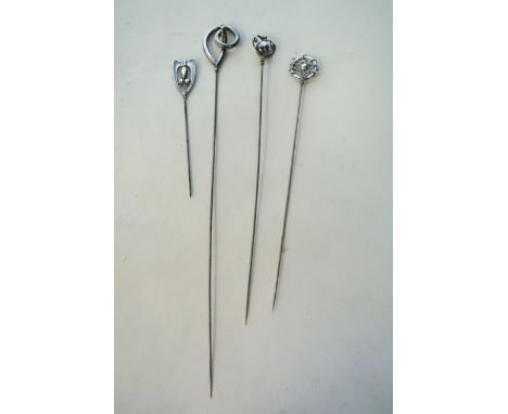 A collection of four silver hatpins, Charles Horner, Chester, 1907 - 1912, with various decorative terminals, pin 8.2cm to 24