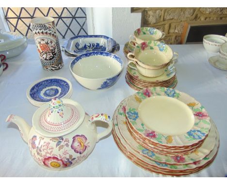 A collection of Masons Sampler pattern dinner wares comprising an oval serving plate, four two handled soup bowls and saucers