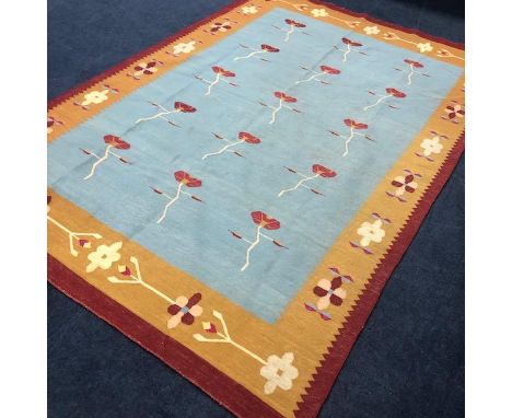 KELIM BORDERED RUG, decorated with rows of single stylised flowerheads, on a light blue ground, 270cm x 182cm