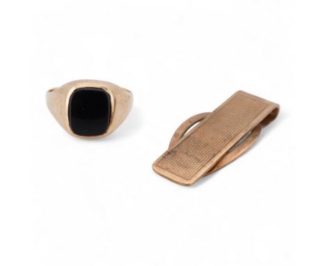 A 1980's 9ct gold tie clip, 39mm and a similar 9ct gold and black onyx set signet ring, gross weight 10 grams.