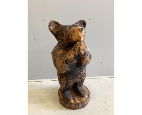 A garden chain saw carving of a standing bear together with a painted reconstituted stone Captain Manwaring garden ornament, 